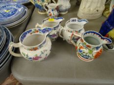 Group of four 19th Century pottery jugs in chinoiserie and handpainted designs