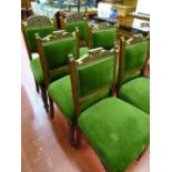 Set of four Edwardian oak upholstered dining chairs with carved detail plus two similar but non-