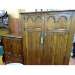 Quality oak linenfold two piece bedroom set of double wardrobe and tallboy with Gothic type detail