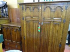 Quality oak linenfold two piece bedroom set of double wardrobe and tallboy with Gothic type detail