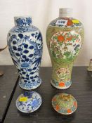 Two Oriental baluster vases with lids