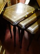 Set of three reproduction mahogany leather topped occasional tables with glass tops