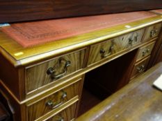 Good reproduction mahogany pedestal desk with gilt tooled red leather inset