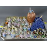 Good collection of porcelain pin cushion dolls and miniature Toby jugs