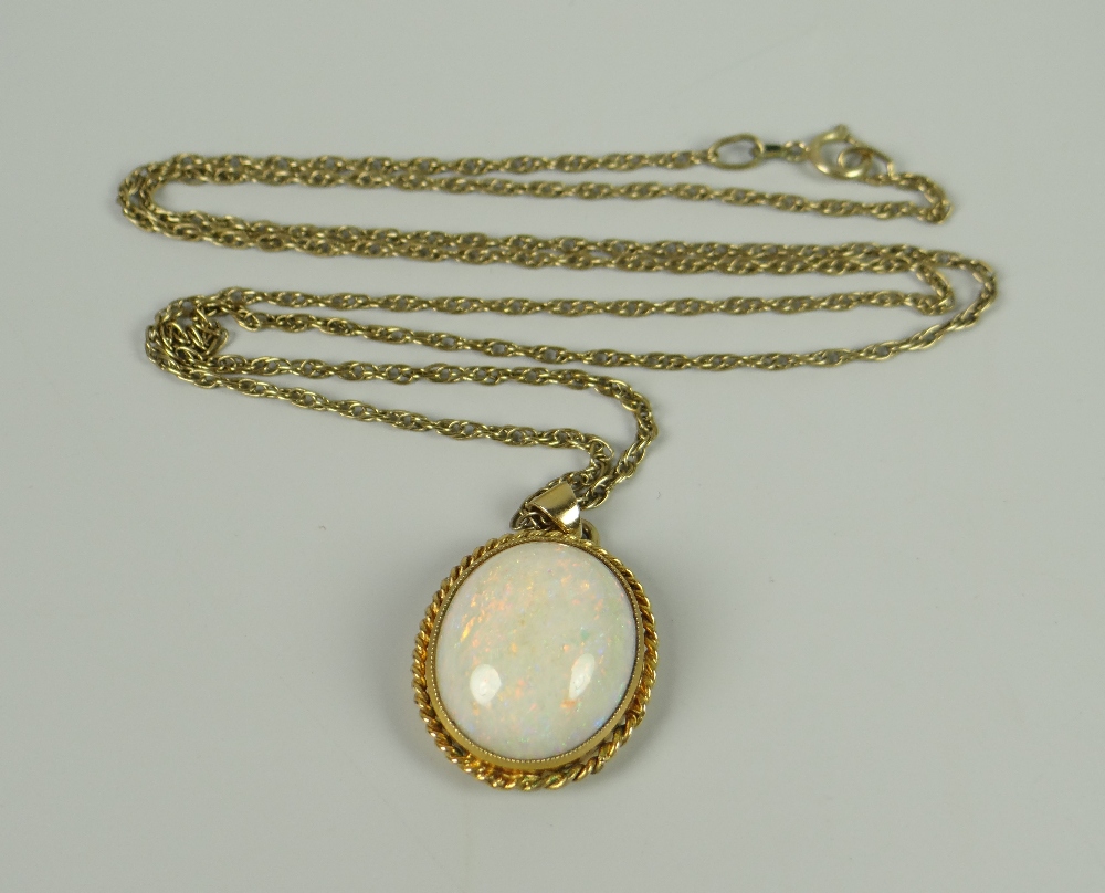 A LARGE WHITE OPAL OVAL PENDANT within 9ct gold rope frame on 9ct necklace, 8.1grams approx.