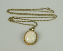 A LARGE WHITE OPAL OVAL PENDANT within 9ct gold rope frame on 9ct necklace, 8.1grams approx.