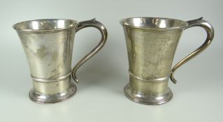 A PAIR OF SILVER TANKARDS of plain tapering form with spreading foot and spurred scroll handle,