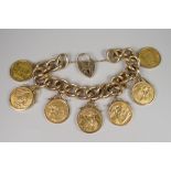 A 9CT GOLD HEAVY CURB LINK BRACELET having seven gold full sovereigns & engraved heart shaped