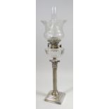 AN ANTIQUE SILVER PLATED CORINTHIAN COLUMN OIL LAMP on a stepped base, with cut-glass reservoir &