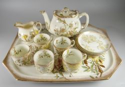 A GEORGE JONES PORCELAIN FLORAL CABARET SET comprising tray, teapot, cream jug, five cups & five