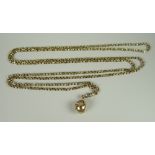 A 9CT GOLD MASONIC BALL suspended from long 9ct cable chain, 38.5grams approx.