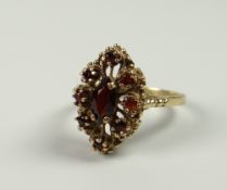 A BELIEVED 9CT YELLOW GOLD GARNET ABSTRACT RING, 4.5grams approx, (size Q)