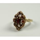 A BELIEVED 9CT YELLOW GOLD GARNET ABSTRACT RING, 4.5grams approx, (size Q)