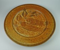 DAVID LLOYD JONES STUDIO POTTERY PLATE of circular form with mottled glaze and traced leaf