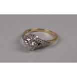 AN ANTIQUE PLATINUM & 18CT GOLD DIAMOND SOLITAIRE SPLIT FLORAL SHOULDER RING, diam 0.8ct visual