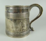 A SILVER TANKARD slightly tapering with continuous rib decoration, engraved crest and s-shaped
