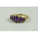 A YELLOW GOLD (MARKS UNCLEAR) FIVE GRADUATED AMETHYST RING, 3.2grams approx, (size N/O)