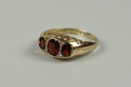 AN ANTIQUE 9CT GOLD THREE-STONE GARNET, 1.9grams approx, (size O)