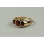 AN ANTIQUE 9CT GOLD THREE-STONE GARNET, 1.9grams approx, (size O)