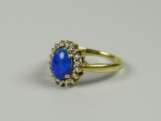 A YELLOW GOLD (MARKS UNCLEAR) BLUE OPAL RING WITH DIAMOND SURROUND, 4grams approx, (size Q)