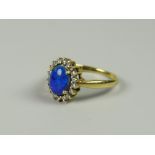 A YELLOW GOLD (MARKS UNCLEAR) BLUE OPAL RING WITH DIAMOND SURROUND, 4grams approx, (size Q)