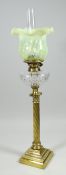AN ANTIQUE BRASS OIL LAMP with twist-style column on a stepped base, cut-glass reservoir &