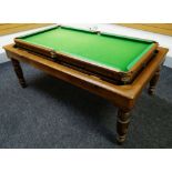 A GEORGE EDWARDS OF LONDON OAK ROLL OVER SNOOKER / DINING TABLE on turned corner supports together