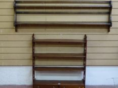 AN ERCOL STYLE WALL RACK and a reproduction mahogany four shelf display rack with twin lower
