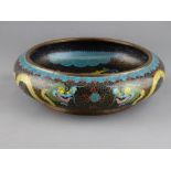 A GOOD CHINESE CLOISONNE DRAGON BOWL, 25 cms diameter, depicting five toed dragons chasing flaming