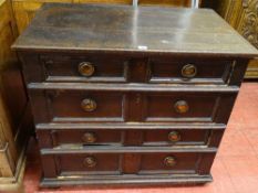 A CONTINENTAL OAK CHEST OF FOUR DRAWERS with copper effect ring pull handles, panel sided on stile