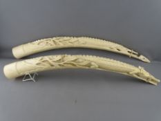 A PAIR OF CIRCA 1920 CROCODILE CARVED IVORY TUSKS, 80 cms long approximately (brought with the