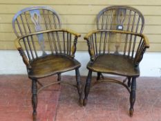 A PAIR OF ELM WINDSOR SPINDLEBACK ARMCHAIRS with pierced splatback and crinoline stretchers, 87