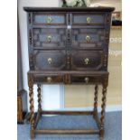 AN OAK, YEW & FRUIT WOOD JACOBEAN CHEST on slightly later stand, having brass petal backplates and