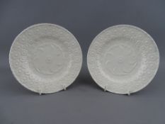 A PAIR OF FLORAL EMBOSSED, POSSIBLY SWANSEA POTTERY COCKLE PLATES, 14 cms diameter