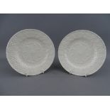 A PAIR OF FLORAL EMBOSSED, POSSIBLY SWANSEA POTTERY COCKLE PLATES, 14 cms diameter