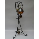 AN ARTS & CRAFTS CHRISTOPHER DRESSER COPPER & BRASS SPIRIT KETTLE on a wrought iron stand with