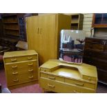 A VINTAGE G-PLAN LIGHT OAK THREE PIECE BEDROOM SUITE of two door wardrobe, mirrored dressing table