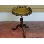 A CIRCULAR TOPPED VICTORIAN STYLE WINE TABLE with baluster gallery top, turned column, on a carved