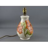 A MOORCROFT 'HIBISCUS' TABLE LAMP, cream ground, 26 cms high overall (crazing)