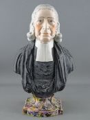 A STAFFORDSHIRE POTTERY BUST OF REVEREND JOHN WESLEY with raised plaque to the rear on a mottled