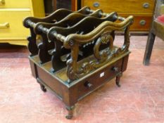 A VICTORIAN ROSEWOOD CANTERBURY with single frieze drawer on brass castors, 53.5 cms high, 53 cms