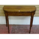 A WILLIAM IV MAHOGANY FOLDOVER TEA TABLE having crossbanded edging and string inlay, on turned and