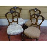 A SET OF FOUR LATE VICTORIAN WALNUT SALON CHAIRS with carved detail to the backs, turned and