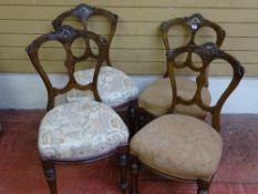 A SET OF FOUR LATE VICTORIAN WALNUT SALON CHAIRS with carved detail to the backs, turned and