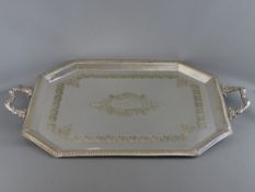 A LARGE TWO HANDLED RECTANGULAR ELECTROPLATE SERVING TRAY with reeded border and central