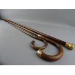 THREE VICTORIAN WALKING STICKS with gold plated caps, two having additional collars, 92.5 cms the