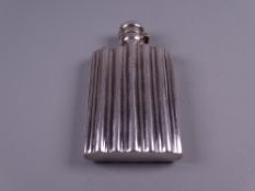 A SILVER POCKET FLASK with ridged decoration and hinged lid, 1.4 troy ozs, Birmingham 1889, maker 'L