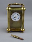 A FRENCH MINIATURE BRASS CASED CARRIAGE CLOCK, the plain gilt mask showing a circular dial with blue