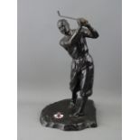 A VINTAGE CAST METAL FIGURE OF A GOLFER, the base set with an oval enamel plaque showing the emblems