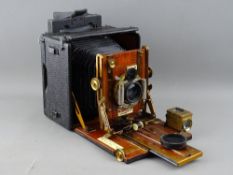 A SANDERSON HAND PLATE CAMERA, mahogany and brass with black square bellows